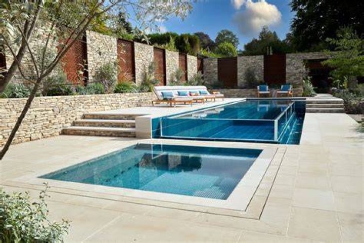 a building with a pool and people in it