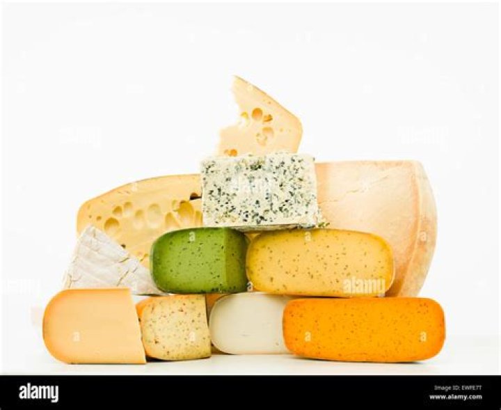 a group of cheeses on a cutting board