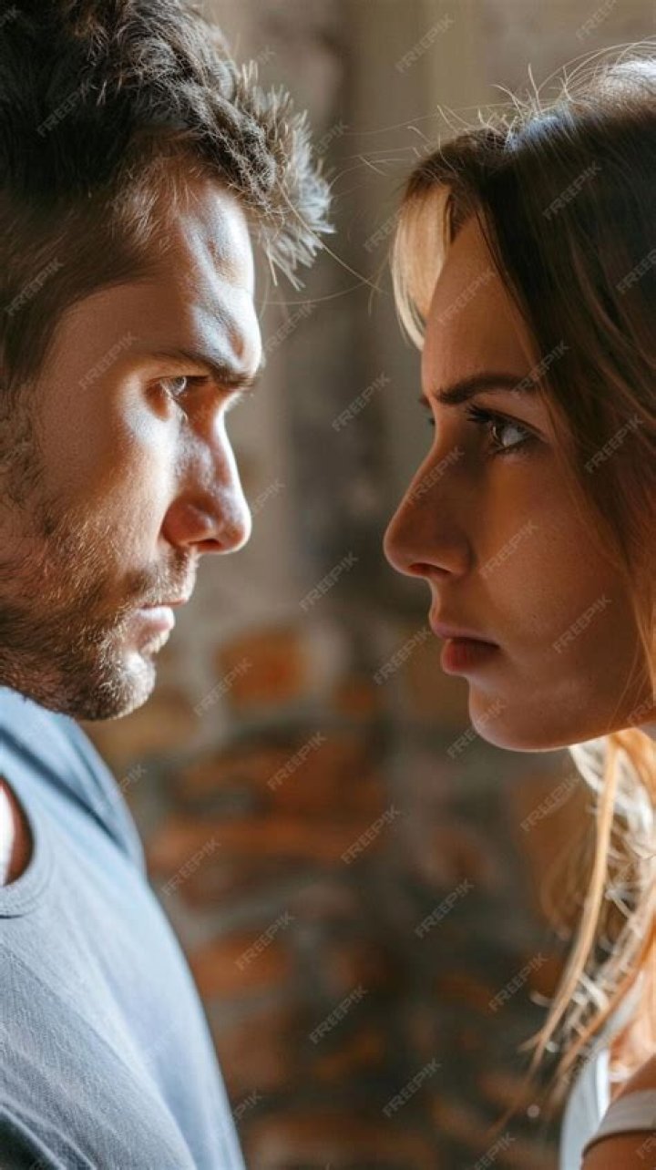 a man and woman staring at one another a man and woman staring at one another