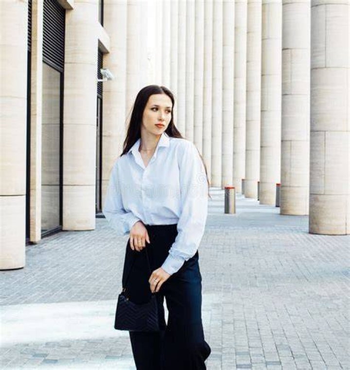 best long skirt outfits 2022 a model wears a long silk skirt and a sweater in a roundup of long skirt outfits 2022