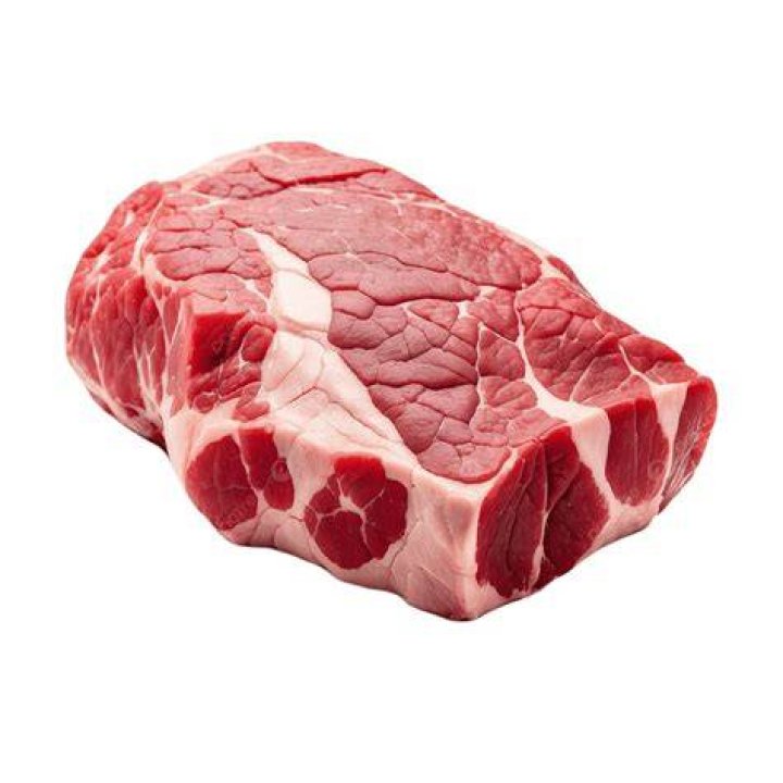 a piece of meat with a green leaf on the side