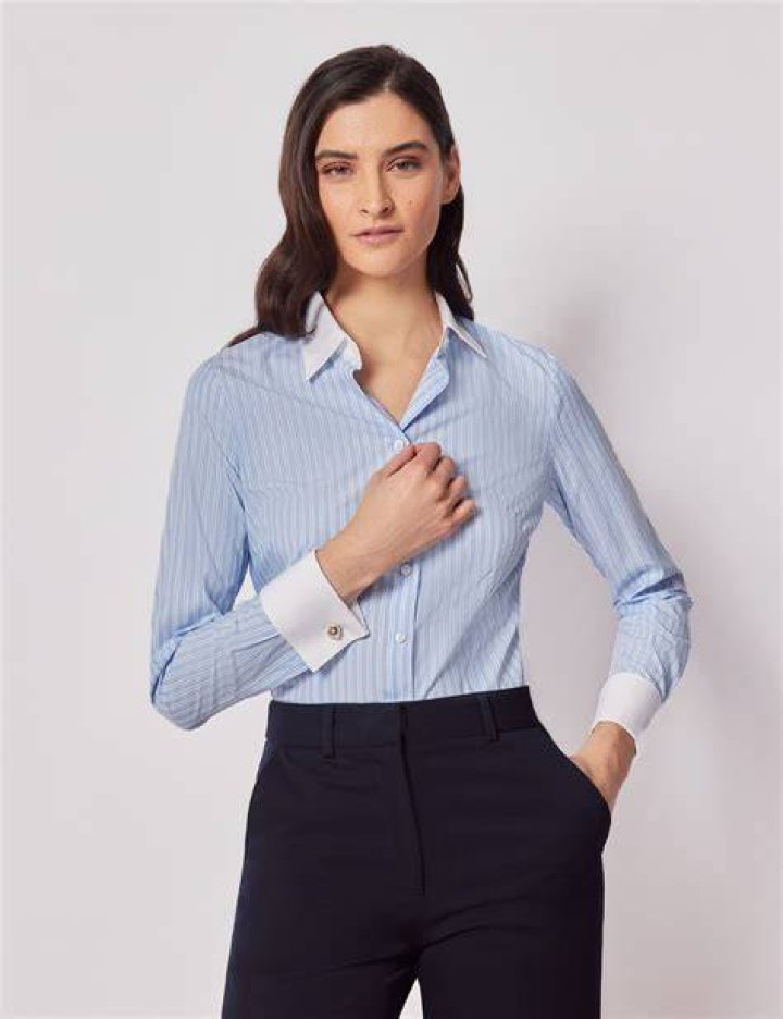 best long skirt outfits 2022 a woman mixes two stripe prints including a long skirt in a roundup of the best long skirt outfits 2022