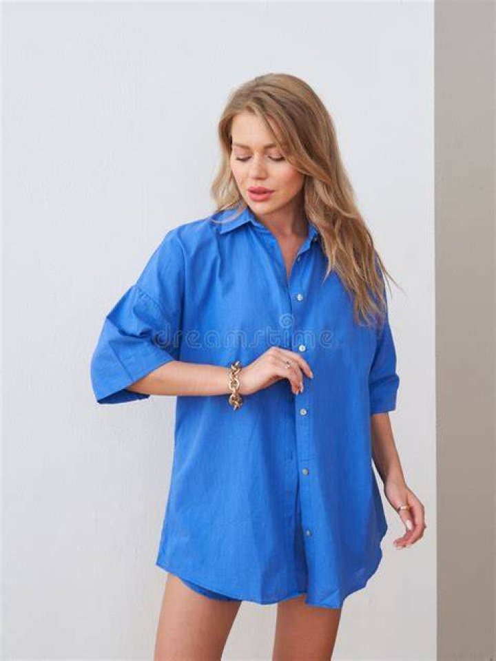 best long skirt outfits 2022 a woman wears a button down shirt and pink long skirt in a roundup of the best long skirt outfits 2022