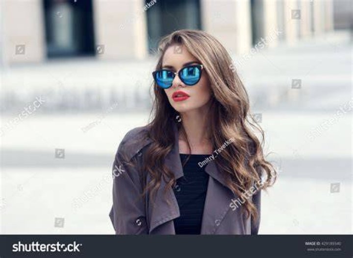 best long skirt outfits 2022 a woman wears a long pleated skirt with a black top tucked in in a roundup of the best long skirt outfits 2022