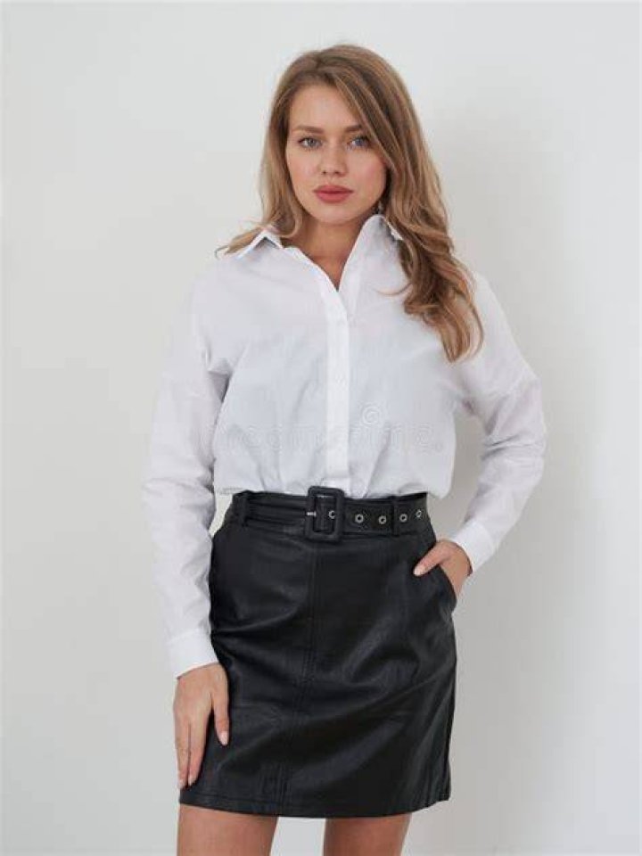 best long skirt outfits 2022 a woman wears a tucked in button down skirt and shirt in a roundup of the best long skirt outfits 2022