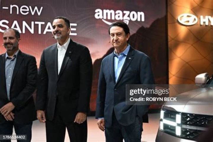 Amazon Vice President Marty Mallick (L) and Hyundai Global President Jose Munoz speak at the media preview day for the Los Angeles Auto Show, on November 16, 2023