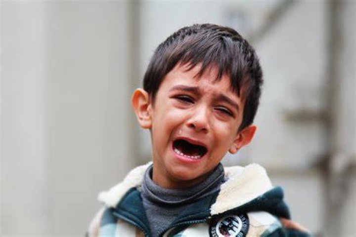 An unhappy sad child crying profusely closeup portrait. An ugly