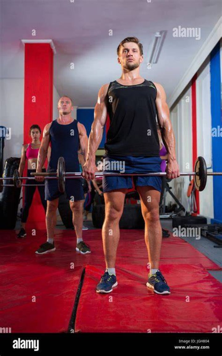 Athletes lifting barbells exercise at gym athletes lifting barbells exercise at gym