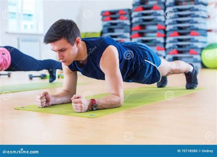 athletic man doing the plank for abs and core
