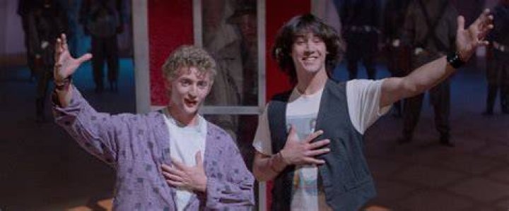 Bill and Ted standing in the street in the early 19th century with Socrates and Billy the Kid behind them with the time machine