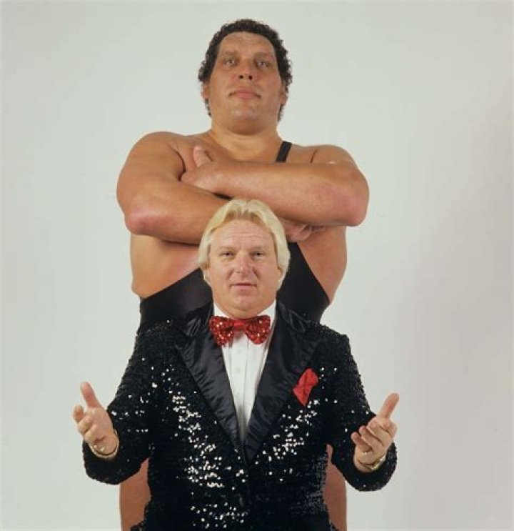 Bobby Heenan standing with Andre and Haku.