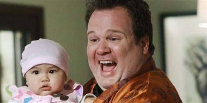 Cam excitedly holds baby Lily in season 1 of Modern Family