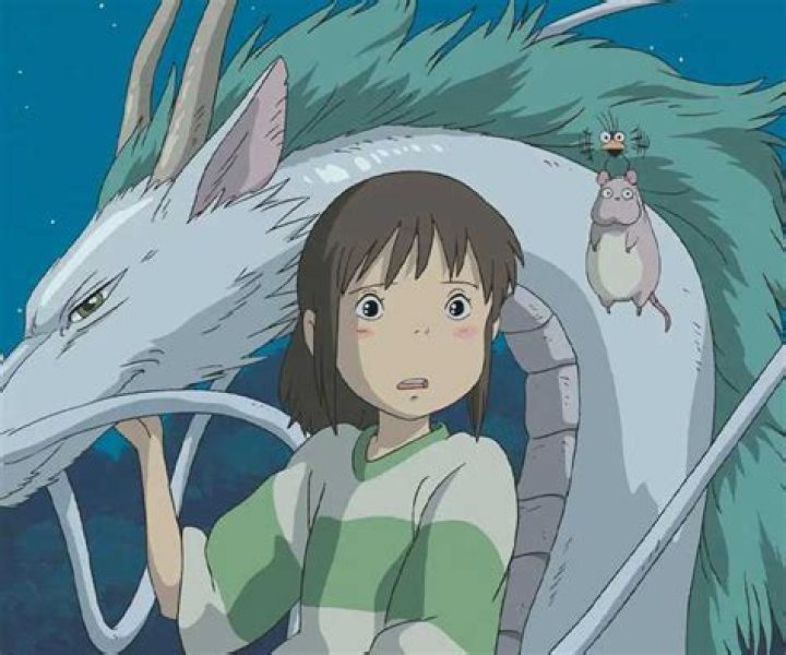 Chihiro Ogino standing with Haku the dragon in Spirited Away