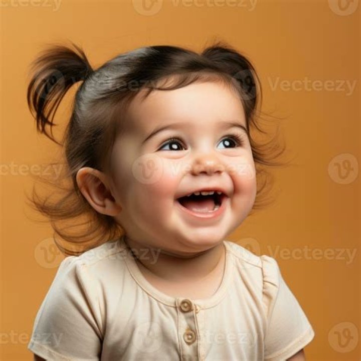 Cute baby girl laughing at her mom