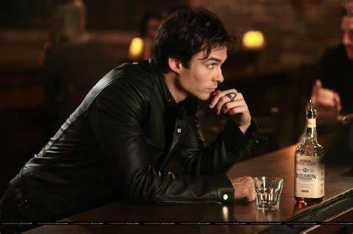 Damon at a bar looking to the distance in TVD