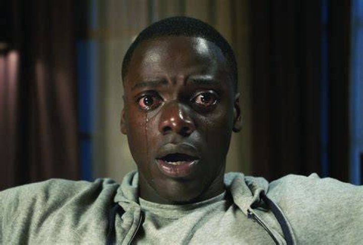 Daniel Kaluuya staring ahead and in tears in Get out