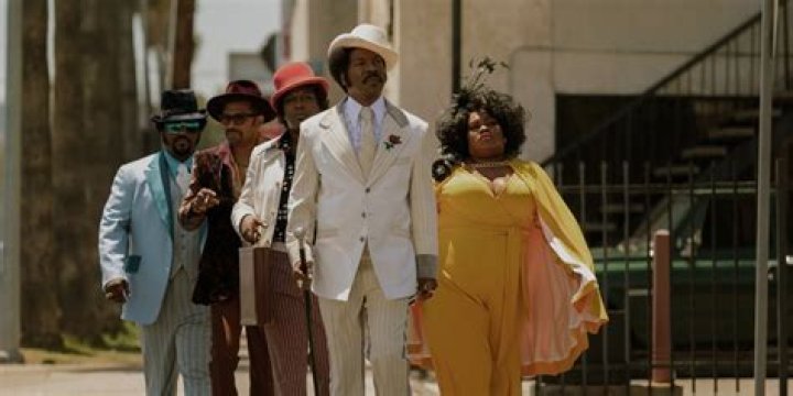 Dolemite walking with his entourage. 