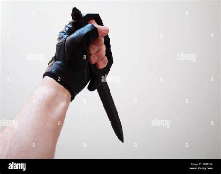 Ewan holding a knife in Cleanskin
