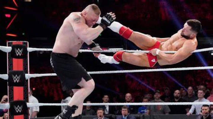 Finn Balor kicks Brock Lesnar