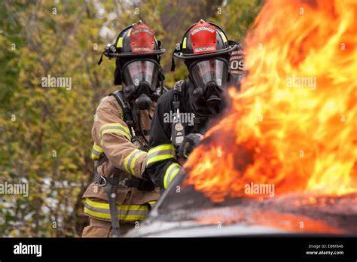 Fire men putting out a fire in an informal settlement