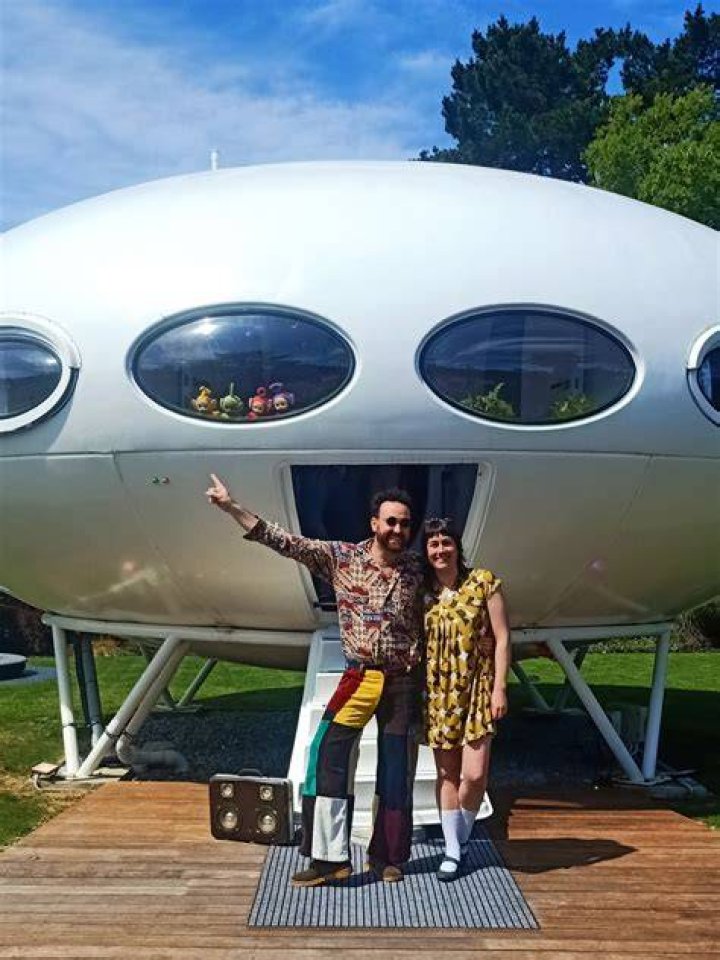 Futuro house collector Nick McQuoid in front of the disassembled gold UFO house from the Christchurch Commonwealth Games. Photo / Thomas Bywater