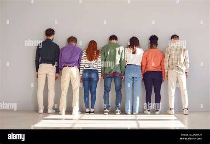Group of people stand facing the camera