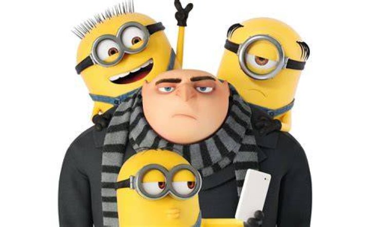 Gru surrounded by minions in Minions The Rise Of Gru 