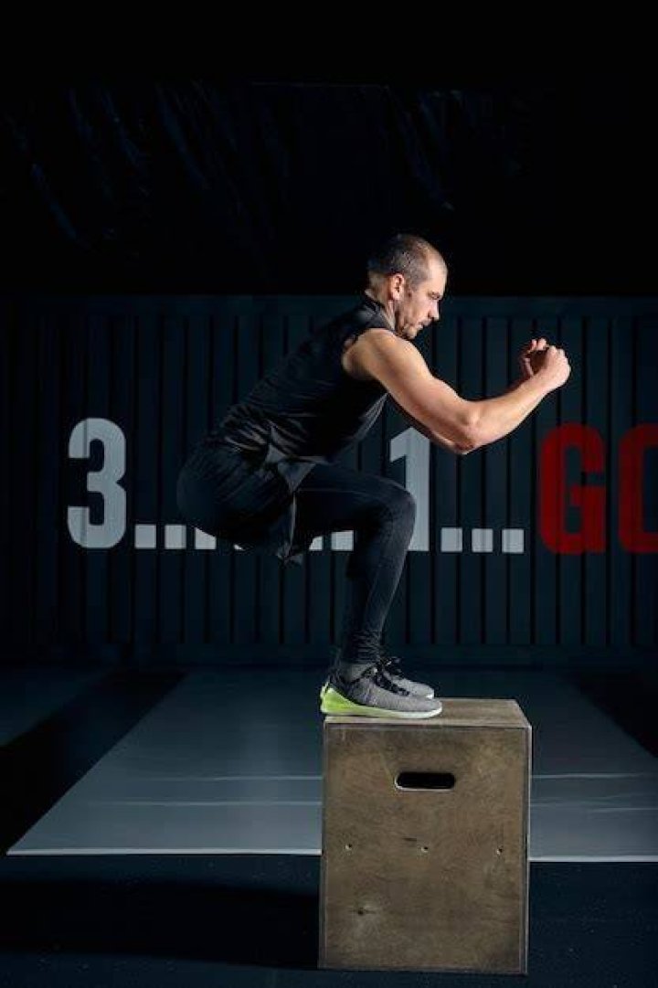gym - man doing box jumps gym man doing box jumps