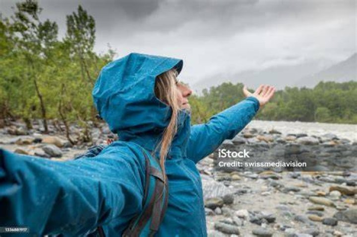 Hiker female under torrential rain
