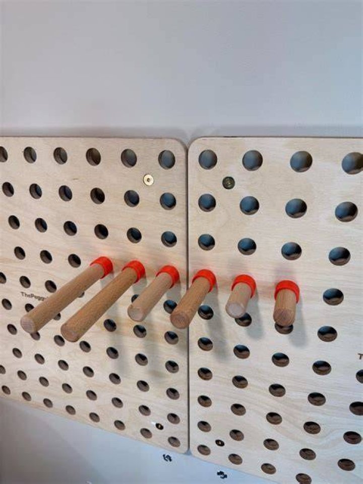 Inserting pegs into wall