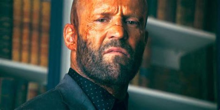 Jason Statham as Clay from The Beekeeper in a beekeeper suit