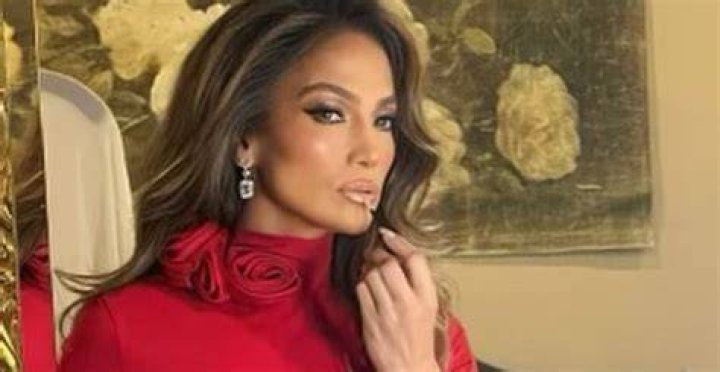 Jennifer Lopez Does Holiday Glamour in Red Rosette Jersey Dress