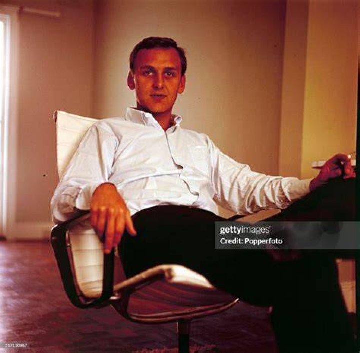 John Parse sitting on a couch, smiling in Possessor