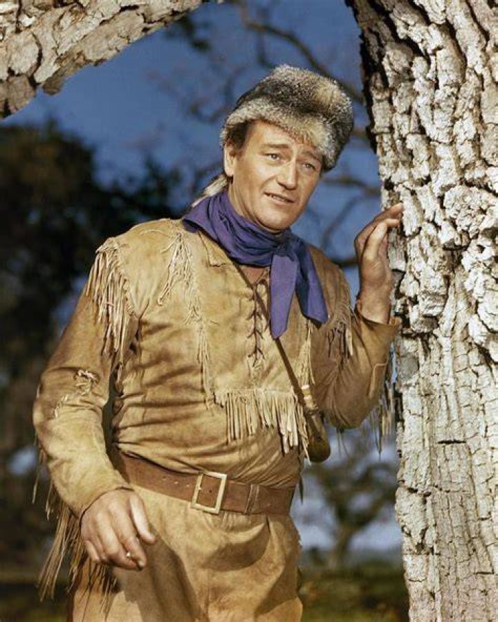 John Wayne outside near a tree in The Fighting Seebees