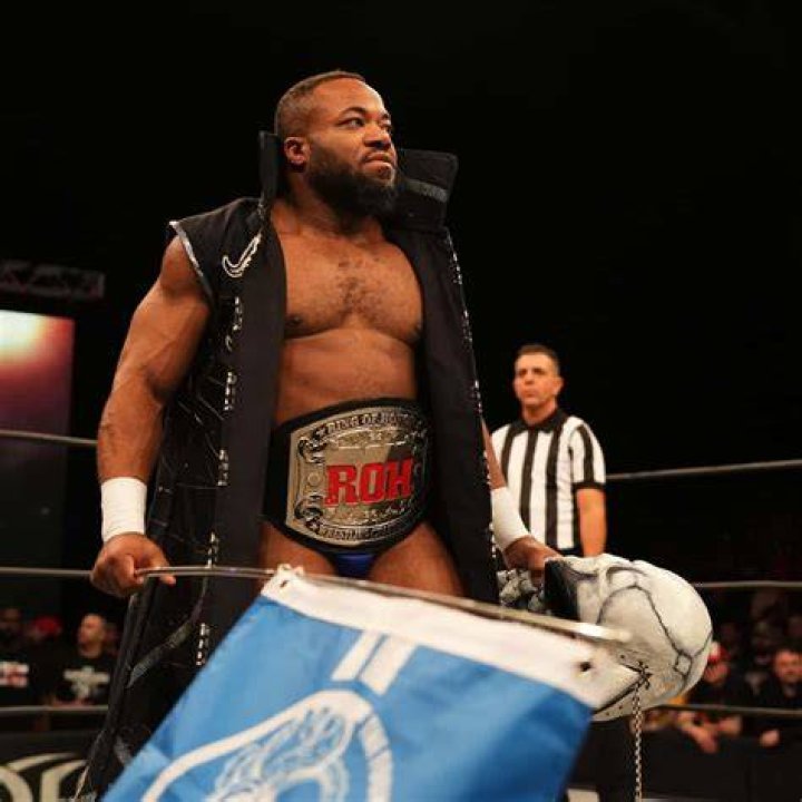 Jonathan Gresham with the ROH and Progress World Championships