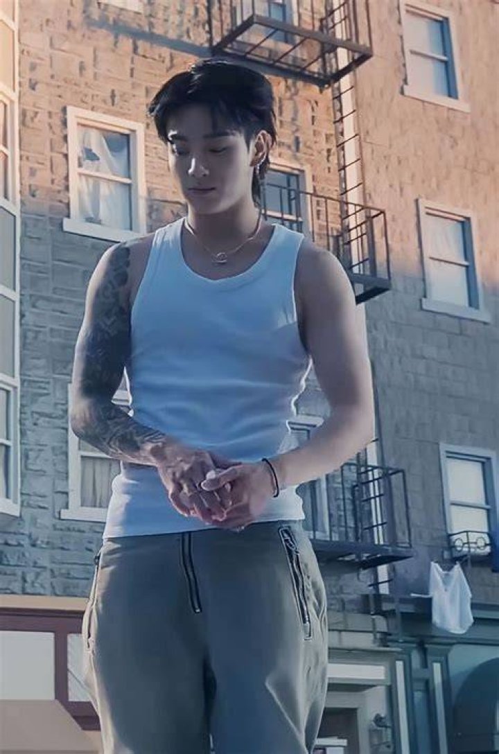 Jungkook wearing a light-coloured tank top (L). The BTS member in a white sleeveless top (R)