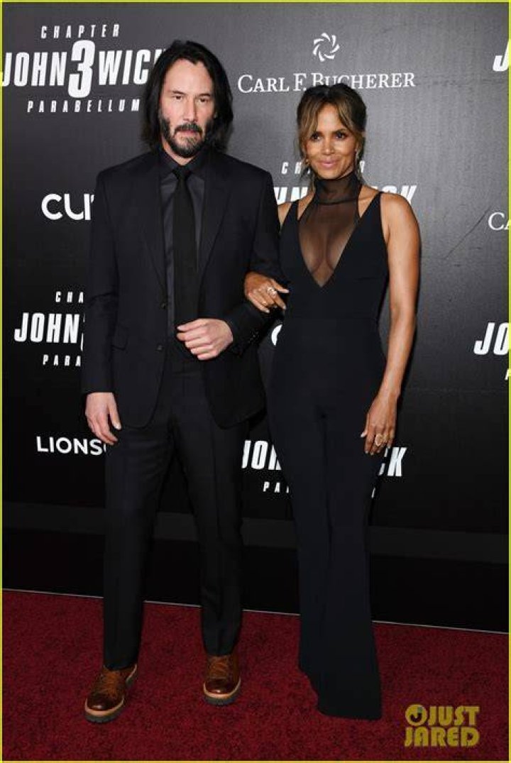 Keanu Reeves and Halle Berry walk through the desert with dogs in John Wick: Chapter 3 - Parabellum