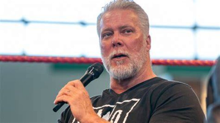 Kevin Nash holding up the WCW Championship. 