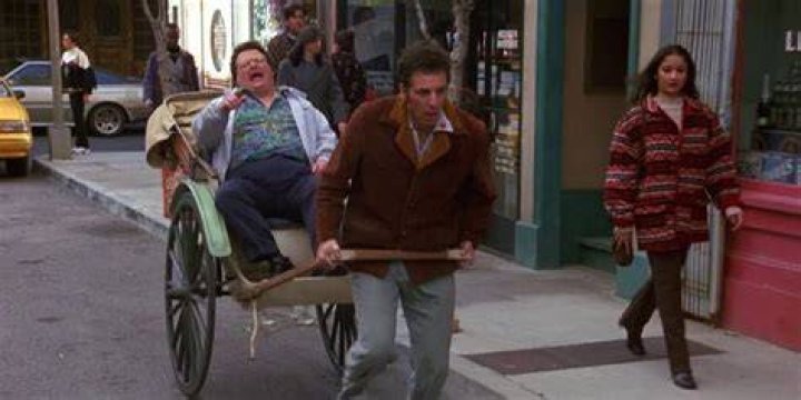 Kramer pulls Newman in a rickshaw in Seinfeld