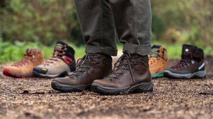 Leather hiking boots walking on mountain trail