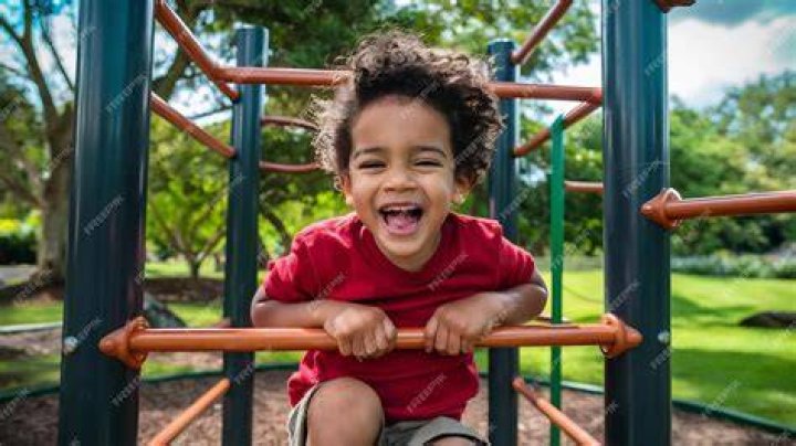 Little boy laughing while playing in water