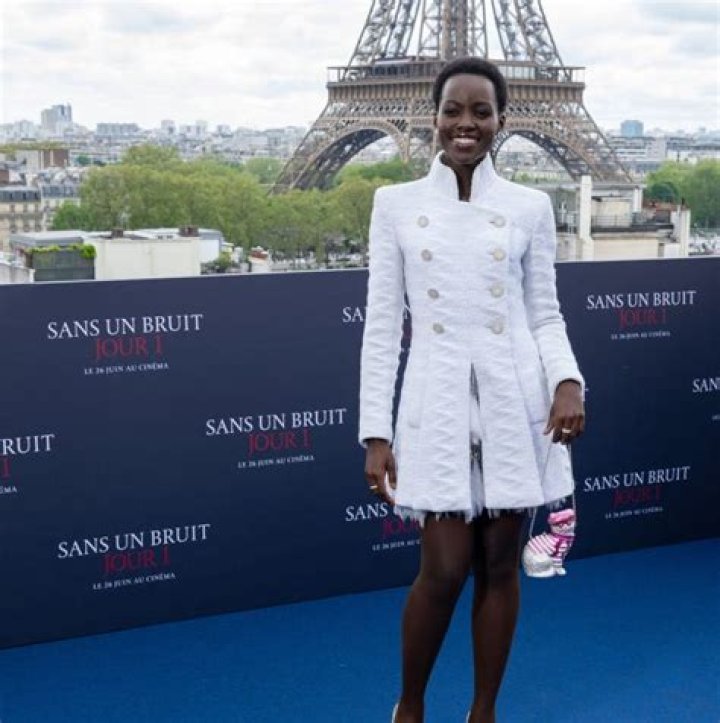 Lupita Nyong'o Accessorizes a Classic Chanel Suit With a Cat-Shaped Purse