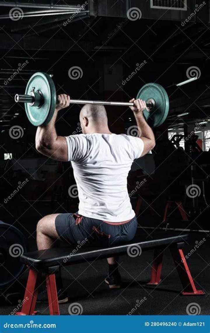 male athlete loading the barbell before the workout