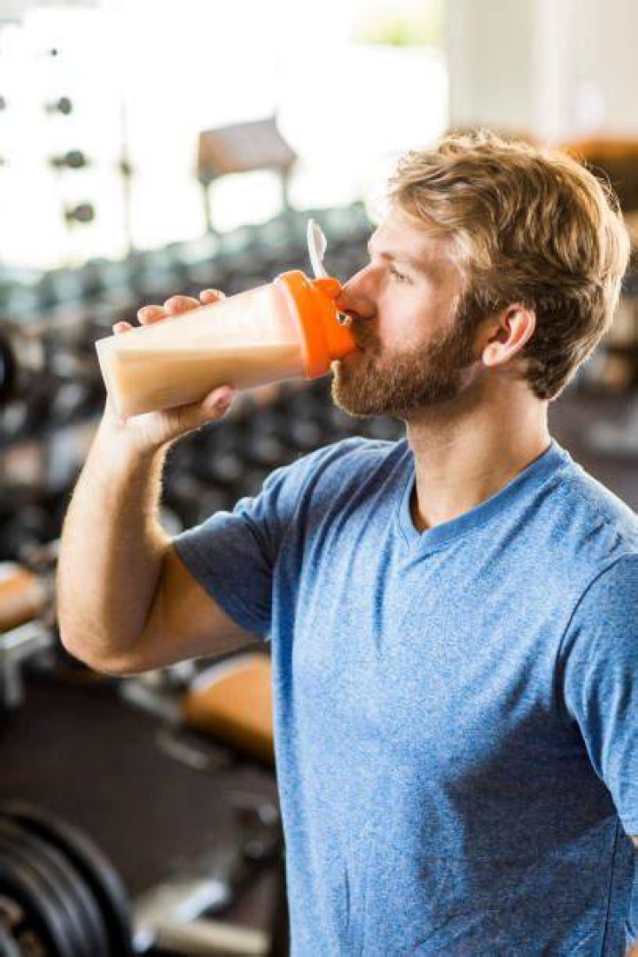 Man drinking protein drink.
