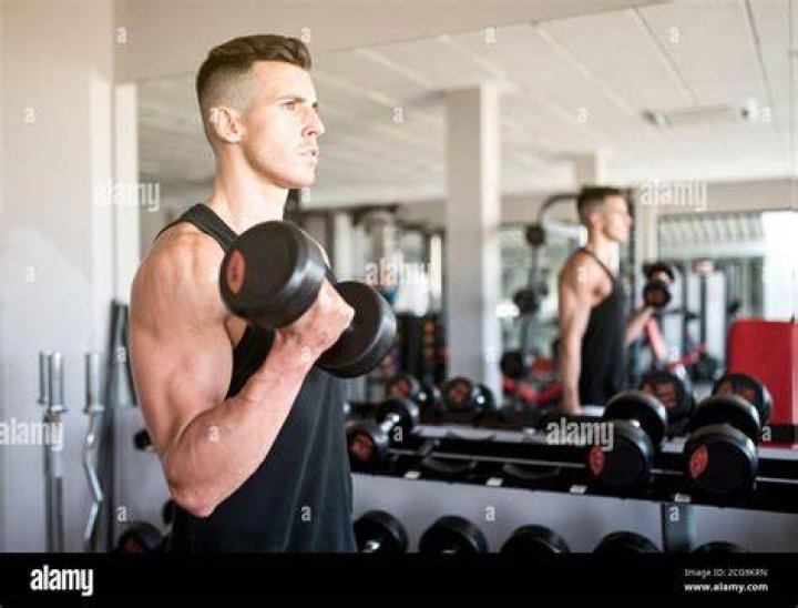 Man training biceps in gym