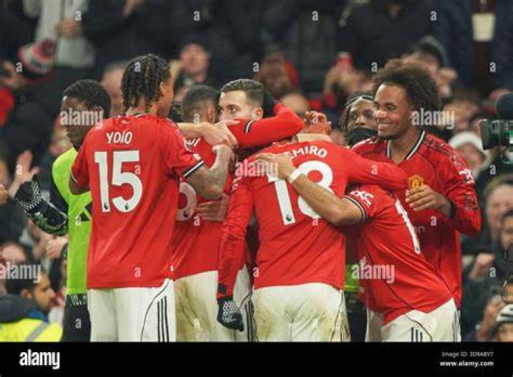 Manchester United players celebrate during the Premier League match between Manchester United and Arsenal FC at Old Trafford. Photo by Shaun Botterill.
