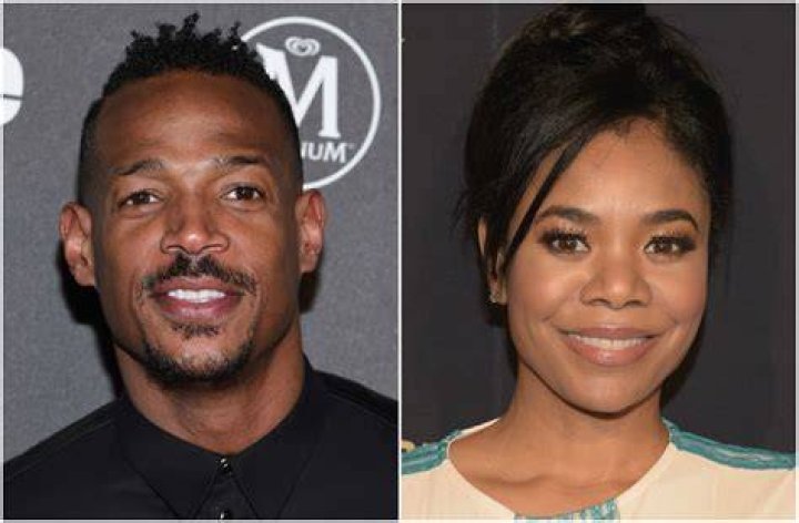 Marlon Wayans and Regina Hall talking at an airport in Netflix's Naked movie