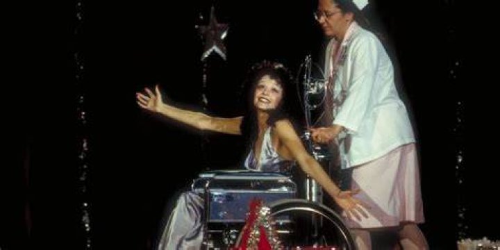 Mary Johanson being pushed on stage on Drop Dead Gorgeous
