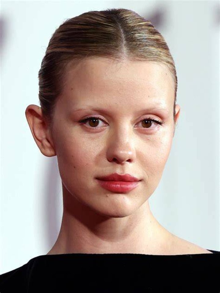 Mia Goth in a looking in a mirror in X