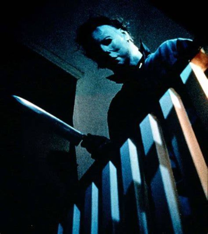 Michael holding a knife above the stairs in Halloween
